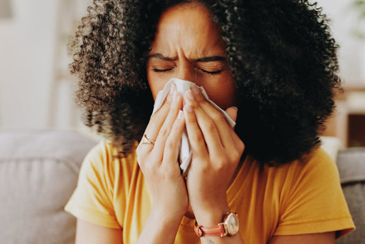 Woman blowing her nose