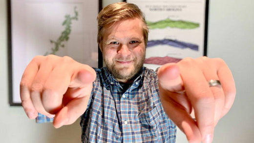 A man pointing towards the camera.