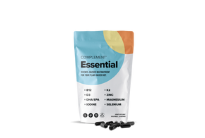 A white and colorful pouch labeled Complement Essential contains plant-based multinutrient supplements. The package lists nutrients: B12, D3, K2, DHA/EPA, iodine, zinc, magnesium, and selenium. Black capsules are displayed below the pouch.