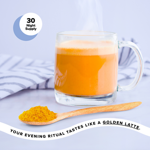 A steaming glass mug of golden latte sits next to a striped cloth, with a wooden spoon holding yellow powder in the foreground. Text reads, Your evening ritual tastes like a golden latte.