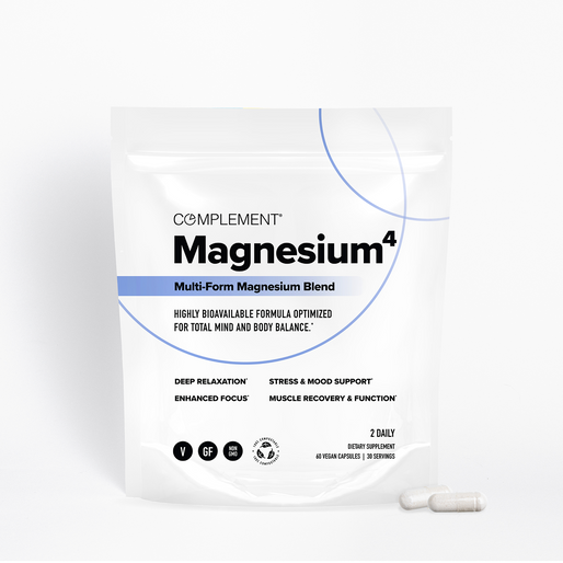A white pouch labeled Complement Magnesium4 Multi-Form Magnesium Blend stands upright with two white capsules beside it. The packaging highlights benefits like relaxation and focus, and mentions its vegan and gluten-free.