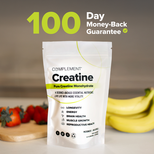 A pouch of Complement Creatine sits on a table near strawberries and bananas. Bold text above reads 100 Day Money-Back Guarantee with a green checkmark. The pouch lists benefits like energy, brain health, and muscle growth.