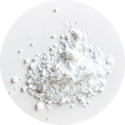 A small mound of fine white powder scattered on a white surface.