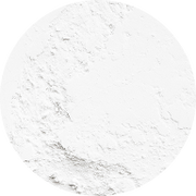 A circular mound of fine white powder with a slightly uneven surface, resembling flour or baking powder, on a plain white background.