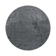A circular piece of dark gray slate with a textured, scratched surface. The stones natural variations create a rugged appearance, giving it a weathered, industrial look.