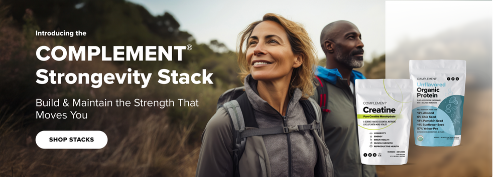 A smiling woman and a man hike outdoors. In the foreground are two protein supplement bags labeled “COMPLEMENT Creatine” and “Unflavored Organic Protein.” Text reads: COMPLEMENT Strongvity Stack. Build & Maintain the Strength That Moves You.