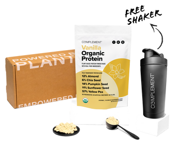 A bag of Complement Vanilla Organic Protein powder, a black shaker bottle, two scoops of powder, and a brown box labeled POWERED BY PLANTS. Ingredients and percentages are listed on the protein bag.