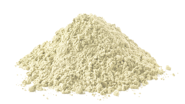 A mound of light beige powdered substance sits against a white background, forming a slightly uneven pile with a fine, grainy texture.