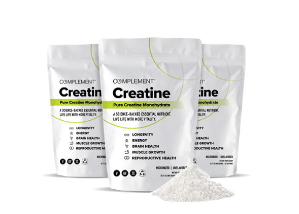 Three packages of Complement Creatine Pure Creatine Monohydrate are displayed with a small pile of white powder in the foreground. The packaging highlights benefits like longevity, energy, brain health, and muscle growth.