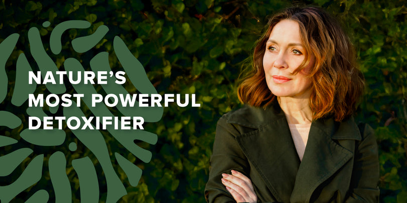 Woman with wavy brown hair in a dark green coat stands outdoors by greenery. Text reads: Nature’s Most Powerful Detoxifier next to a large leafy graphic.