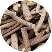 A close-up image of dried licorice roots, showing a collection of brown sticks with rough textures and cut ends. The roots are clustered together, highlighting their fibrous and natural appearance.