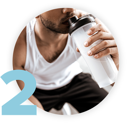 A person in a white tank top is drinking from a shaker bottle. There is a large number 2 in the lower left corner of the image.