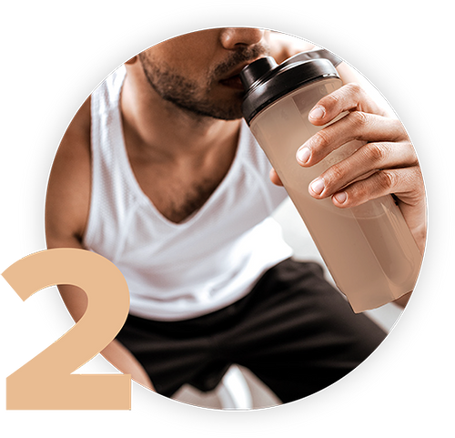 Man in a white tank top drinking from a shaker bottle, with the number 2 in the bottom left corner.