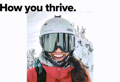 A person wearing a helmet and goggles is smiling while standing in a snowy environment. They are dressed in winter gear with a backpack. The text above reads How you thrive.