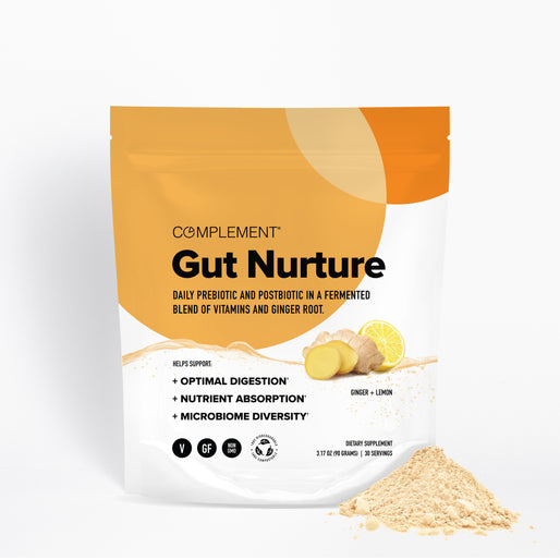 A pouch labeled Complement Gut Nurture with ginger root, lemon slices, and powder in front. The packaging highlights digestion, nutrient absorption, and microbiome diversity benefits.