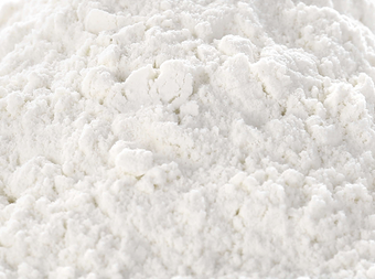 A close-up view of a mound of white, powdery flour with a soft, fine texture.