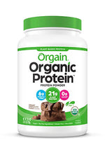 A container of Orgain Organic Protein powder with a green lid. It features labels indicating 21g of plant protein per serving, 6g of fiber, and 0g of sugar. The product is USDA organic and plant-based. The flavor is creamy chocolate fudge.
