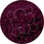 A circular image features a dark purple powdery substance in the background with a white chemical structure overlay showing a complex arrangement of nitrogen-containing ring molecules.