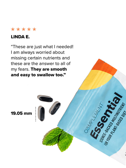 A bag labeled COMPLEMENT® Essential by Complement with black, plant-based capsules beside it, a mint leaf, a review praising their smooth, easy-to-swallow multivitamin capsules, and a capsule length of 19.05 mm.