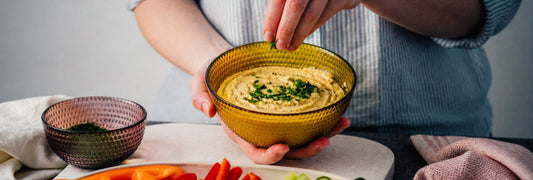 Woman making a bowl of hummus