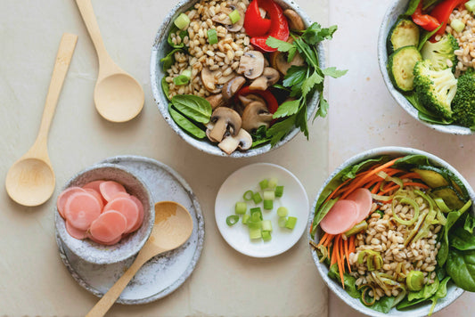 Five bowls on a table with salad ingredients