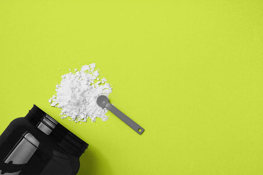 Plastic tub of creatine, with powder and a spoon