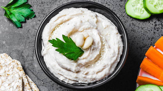 A bowl of sardinian white bean dip surrounded by crudite