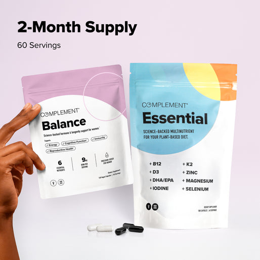 Two supplement pouches labeled Balance and Essential with capsules and softgels below. A hand holds the Balance pouch. Text above reads 2-Month Supply, 60 Servings on a light purple background.