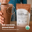 A hand holds a glass of chocolate protein shake with a package of Chocolate Organic Protein powder blurred in the background. Text on image reads: “Kid-approved, parent-loved. USDA Organic.”.
