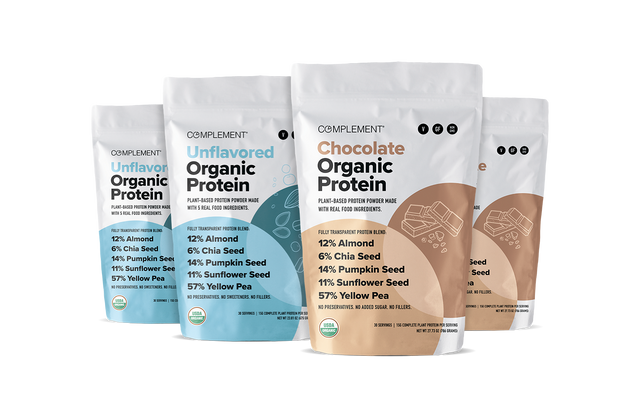 Four standing pouches of Complement Organic Protein powder in Unflavored and Chocolate varieties. Each pouch highlights plant-based protein sources like almond, chia seed, pumpkin seed, sunflower seed, and yellow pea.