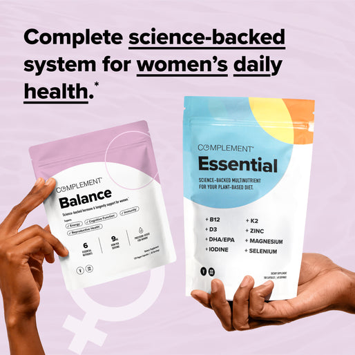Two hands hold pouches labeled Balance and Essential from Complement. Text above reads Complete science-backed system for womens daily health on a pink background with a female gender symbol.