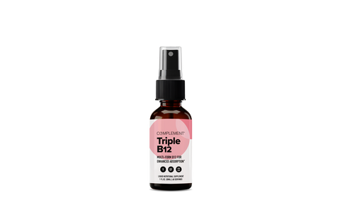 A brown glass spray bottle labeled Complement Triple B12 with a black spray cap, white label, and pink geometric design, set against a plain white background.