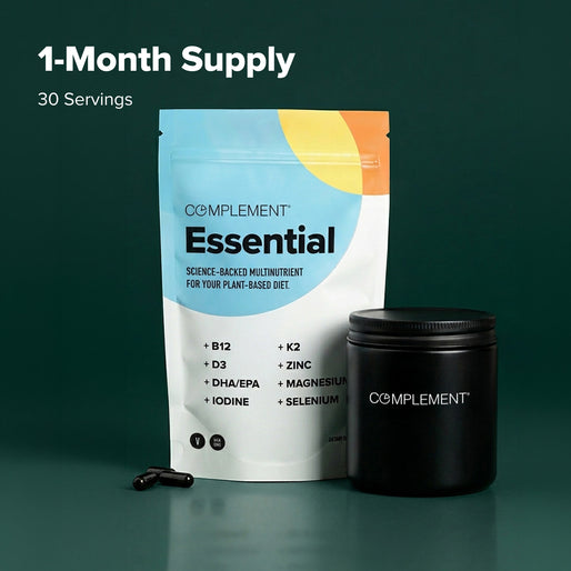 A pouch labeled Complement Essential and a black container with capsules are displayed against a dark green background. Text above reads 1-Month Supply, 30 Servings.