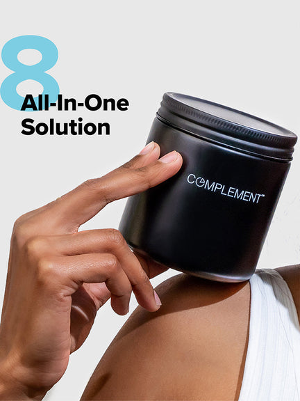 A person holds a black jar labeled COMPLEMENT against a light background. The number 8 and the text All-In-One Solution are seen next to the jar.