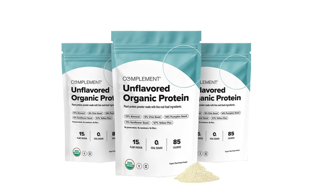 Three pouches of Complement Unflavored Organic Protein powder arranged in a row, with a small pile of powder in the foreground.