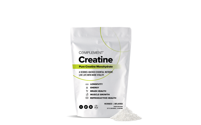 A white pouch labeled Complement Creatine Pure Creatine Monohydrate stands upright with a small mound of white powder beside it. The packaging lists benefits like energy, muscle growth, brain, and reproductive health.