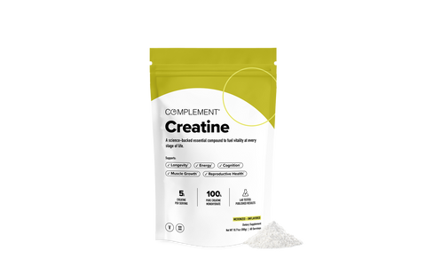 A white and yellow pouch labeled Complement Creatine stands upright with a small pile of white powder beside it, against a plain white background. The packaging highlights benefits and product details in black text.