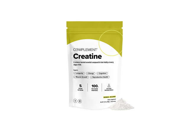 A white and yellow pouch labeled Complement Creatine stands upright with a small pile of white powder beside it, against a plain white background. The packaging highlights benefits and product details in black text.