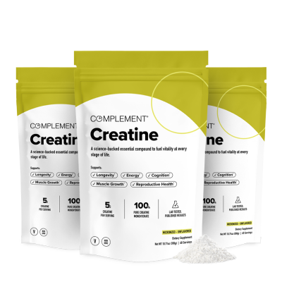 Three white and yellow pouches labeled “Creatine” from Complement are shown, with a small pile of white powder in front. The packaging highlights benefits like muscle growth, cognition, and longevity.