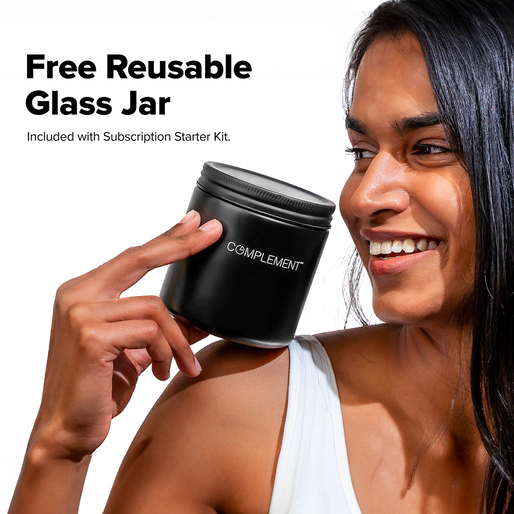 A smiling person in a white shirt holds a black COMPLEMENT® ForHer Essential System jar by Complement. Text: Free Reusable Glass Jar with Subscription Starter Kit. This women’s plant-based supplement supports longevity.