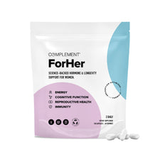 A pouch of Complement ForHer supplements is displayed. The packaging highlights benefits such as energy, cognitive function, reproductive health, and immunity. Three capsules are laying next to the bag.