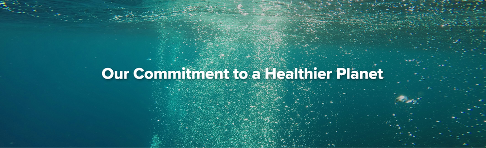 Underwater scene with bubbles rising toward the surface, overlaid with the text Our Commitment to a Healthier Planet in bold white letters.