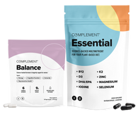 Two supplement packages: one labeled Balance in purple and white, and a larger one labeled Essential in blue and white, both from Complement, with capsules displayed in front of each package.