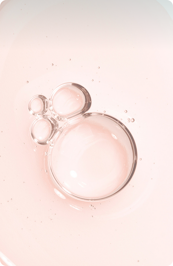 Clear bubbles of different sizes float on a light pink background, arranged in a cluster that resembles the shape of a mouses head.