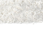 A close-up view of a mound of fine white powder, resembling flour, on a white background.