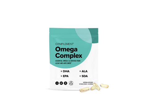 A teal and white package labeled Complement Omega Complex with text highlighting DHA, EPA, ALA, and SDA. Four yellowish capsules are placed in front of the package on a white background.