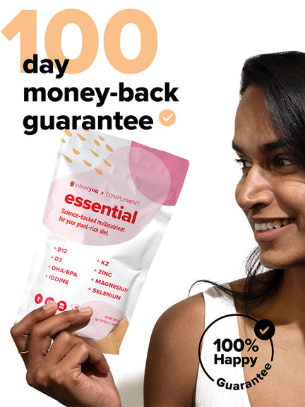A person smiling holds a white and pink pouch labeled essential, a plant-based multinutrient. Text on image: 100 day money-back guarantee and 100% Happy Guarantee. The pouch lists nutrients like B12, D3, DHA/EPA, Iodine, K2, Zinc, Magnesium, Selenium.