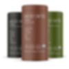 Three cylindrical containers—black, brown, and green—stand upright side by side. The text on the containers is blurry and unreadable. The background is plain white.
