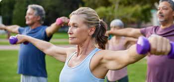 A group of people exercising with dumbbells.