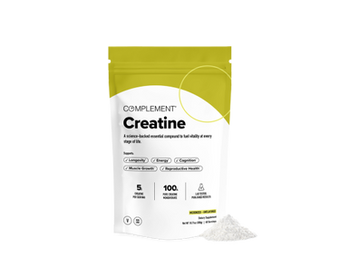 A yellow and white pouch labeled Complement Creatine stands upright with white creatine powder spilled beside it. The packaging highlights benefits like longevity, energy, and cognition.